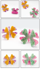 Macro detail of acetate butterfly hair claw clips with diamond accents and colorful patterns