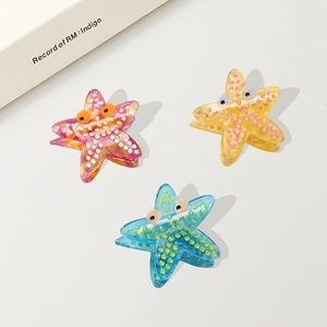Starfish hair clips in acetate with colorful polka dots and cute cartoon eye design