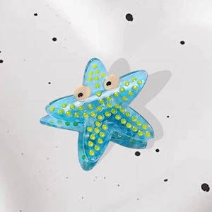 Elegant blue sea star acetate hair claw with yellow dots and cute cartoon eyes design