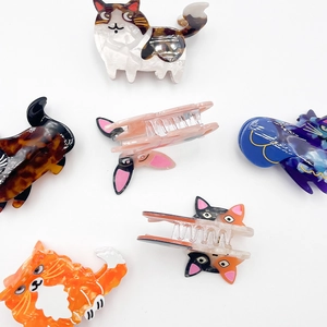 Set of six cat-shaped acetate hair claws in various marbled and tortoiseshell patterns