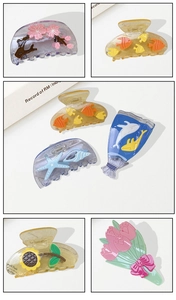 Detailed view of ocean-themed and floral acetate hair claws with transparent resin textures