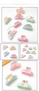Detailed macro view of colorful Easter resin hair claws with glitter and floral patterns