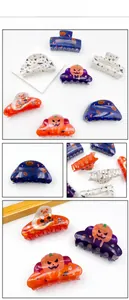 Detail view of acrylic Halloween hair clips featuring pumpkin and ghost patterns