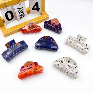 Halloween acrylic hair claws featuring spooky pumpkin and bat designs for festive styling