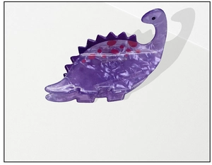 Detail view of purple acrylic dinosaur hair claw clip with marble texture and red dots