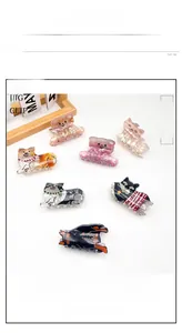 Close-up of cute cartoon bear and dog hair claws with marble texture finish