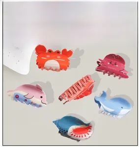 Flat lay of colorful cartoon sea creature hair claws including crab and octopus designs