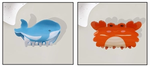 Detailed view of cute blue whale and orange crab shaped hair claws made of glossy PVC