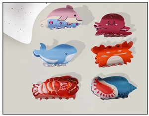 Detail view of 6-piece sea animal hair claw set featuring dolphin, octopus, and crab shapes