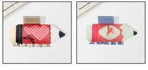 Detail of creative pencil-shaped hair clips with heart patterns and Love text