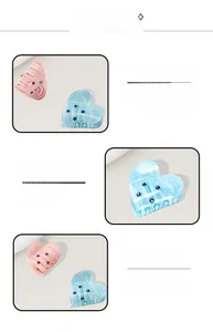 Detailed macro view of heart-shaped hair claw clips with marble texture and small rhinestones