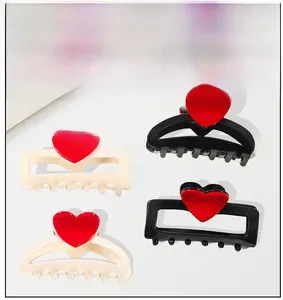 Détails des pinces à cheveux à motif cœur en noir et crème avec des accents rouges