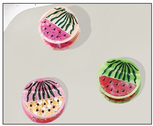 Detailed macro view of three colorful watermelon-themed acetate hair claws in various summer colors