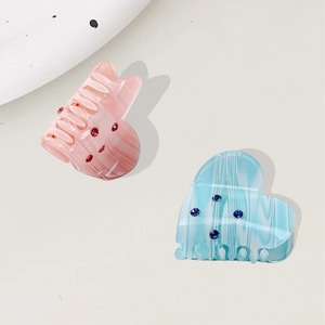 Elegant heart-shaped acetate hair claws with marble texture and rhinestones for women