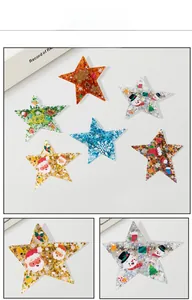 Macro detail of acrylic Christmas star charms featuring festive patterns and glitter finish
