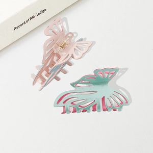 Elegant butterfly hair claws in matte pink and mint green PVC with glitter finish