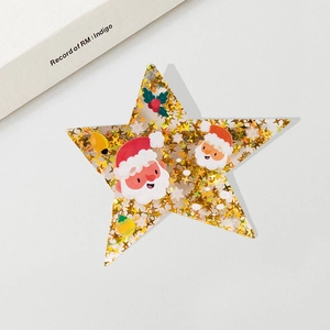 Christmas star hair clip with golden sequins and Santa illustration for festive hair styling
