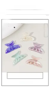 Detail of coral-textured acrylic hair claws with pearl accents in five pastel colors