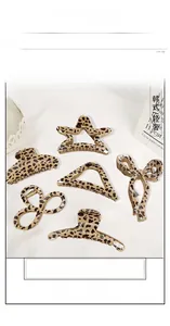 Detailed macro view of assorted leopard print hair claw clips in various geometric shapes