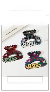 Detailed view of floral acetate heart hair claws with marble texture and rhinestones