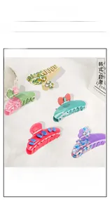Flat lay of colorful acetate hair claws with flower patterns and crystal embellishments