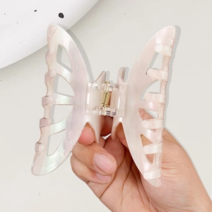Pink butterfly hair claw with pearlescent finish and openwork design for women