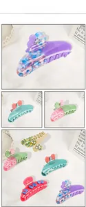 Detail view of acetate flower hair claw clips with sparkling rhinestones in various colors