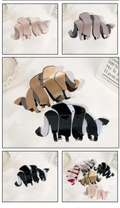 Close-up of elegant acetate hair claws in various colors with a chic scalloped design