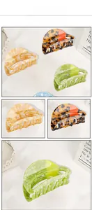 Three acetate hair claws in amber, green marble, and orange pattern finishes