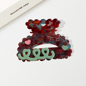Scalloped marble red acetate hair claw clip with colorful heart relief patterns