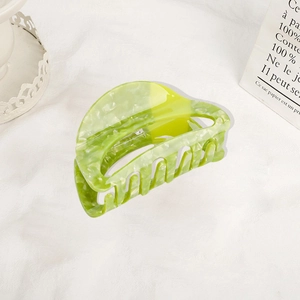 Elegant marble green and yellow acetate hair claw clip on a stylish French background