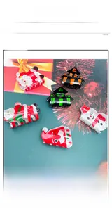 Detail view of colorful acrylic Christmas hair claws with Santa and snowman motifs