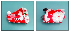 Detailed view of red and white Santa Claus hair claws made of marble-textured acetate