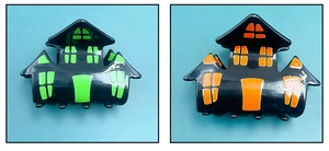 Detailed macro view of black haunted house hair claws with festive green and orange windows