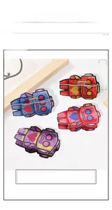 Detail view of four robot-shaped hair claws with glitter texture and heart accents