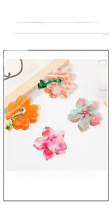 Detail view of large acetate floral hair clips with sparkling crystal rhinestones set