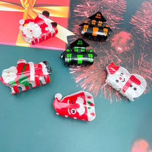 Festive Christmas and Halloween hair claws with Santa, snowman and haunted house designs