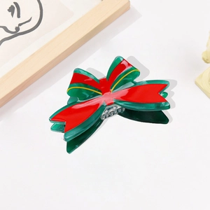 Pince à cheveux noeud de Noël en acétate vert et rouge avec bordure dorée élégante