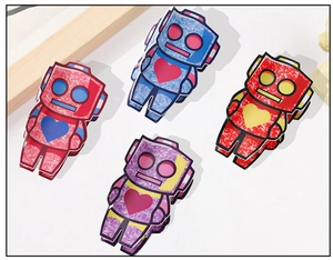 Detailed view of colorful glitter acetate robot hair claws with heart patterns