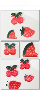 Macro shot of cute cherry, watermelon, and strawberry hair clips with wavy texture