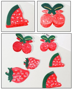 Detail showing acetate fruit hair clips in watermelon cherry and strawberry shapes