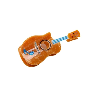 Guitar-shaped amber acetate hair claw clip with colorful rhinestones and music notes