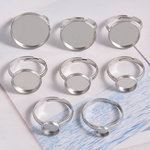 Set of silver adjustable stainless steel ring blanks with various round tray sizes for DIY