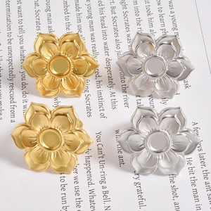 Macro detail of gold and silver six-petal flower metal ring bases with matte finish