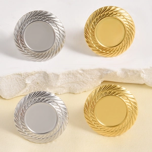 Macro detail of round gold and silver metal ring settings with textured wheat edges