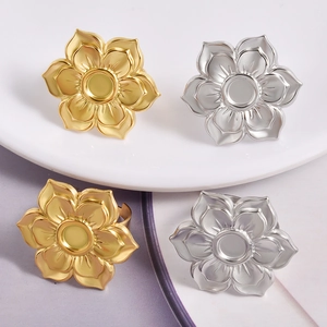 Detailed view of silver and gold lotus flower rings with metal petal settings