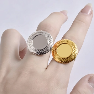Minimalist stainless steel ring blanks in gold and silver with textured edges on fingers