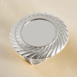 Macro view of silver stainless steel ring with radial feather texture and flat center disc