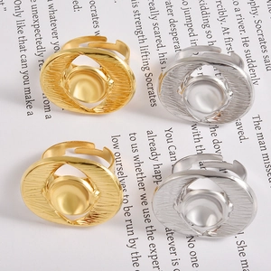 Detailed view of four adjustable textured geometric metal rings in gold and silver finish