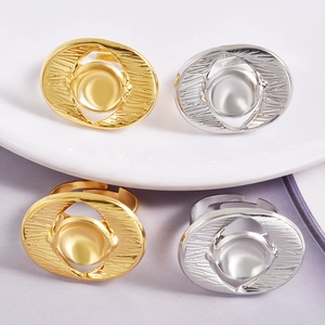 Detailed view of gold and silver oval DIY ring bases with textured sunburst edge design